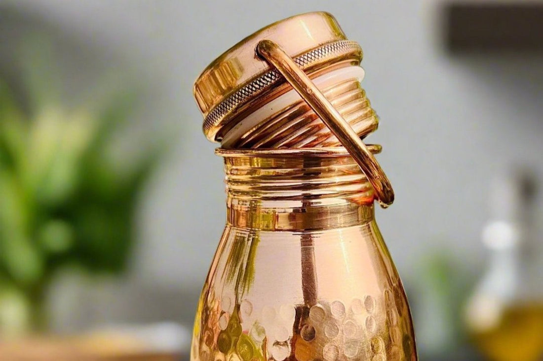 Pure copper water bottle with handle, handmade by Kaarigar, for making copper-charged water